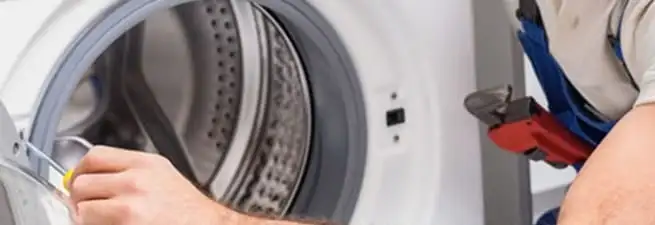 Appliance technician repairing a clothes dryer drum and internal parts in Philadelphia, PA