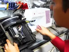 Vacuum repair technician servicing internal components on a workbench in Philadelphia, PA