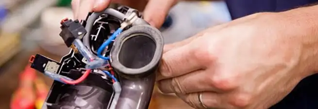 Vacuum repair technician reconnecting wiring and components in Philadelphia, PA